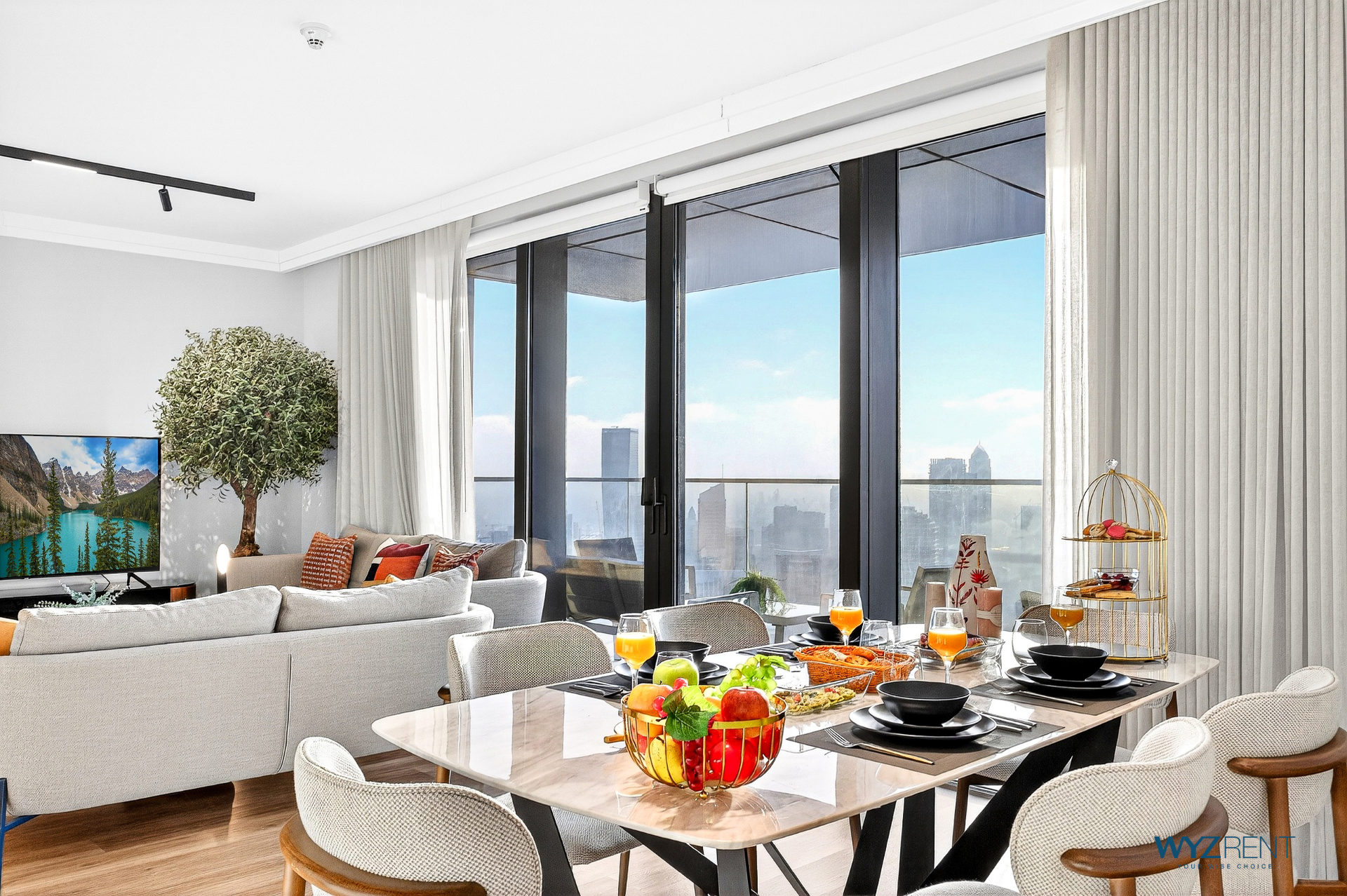 Elegant dining area with panoramic Dubai skyline views in WYZ Rent managed luxury short-term rental apartment